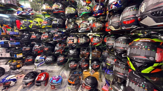 Ceiling-high shelves packed with helmets at Speed World