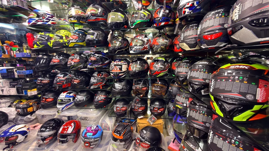 A wall of helmets across types and sizes at Speed World